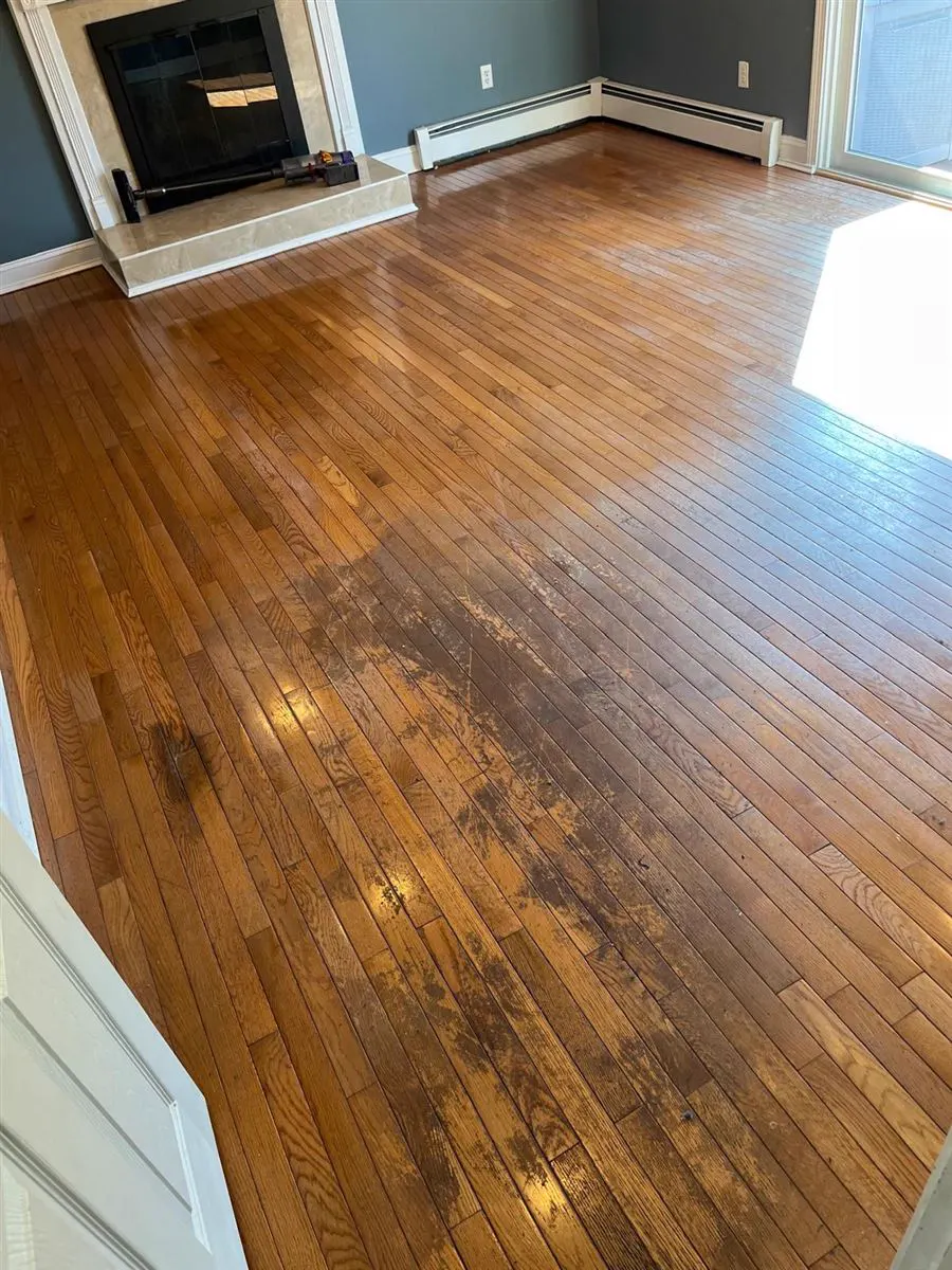 Worn oak strip floor with dark stains, before refinishing