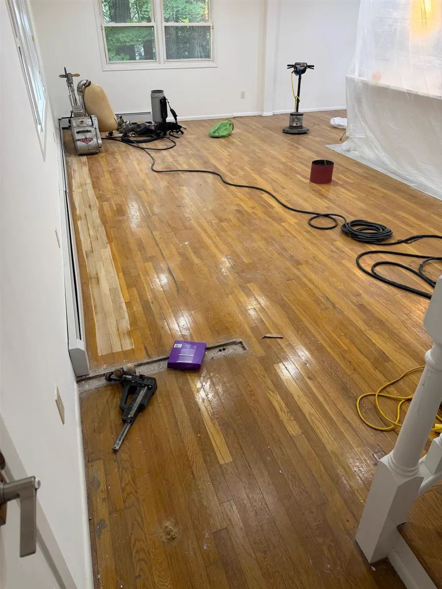 Sanding machines and tools on an oak floor during a refinishing job